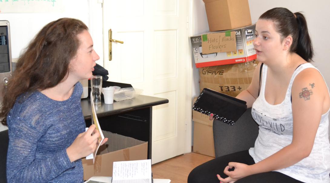 Teenage volunteer chat with each other about different interview techniques during their Journalism Project Journalism volunteers practice their interviewing skills as part of their project in Romania